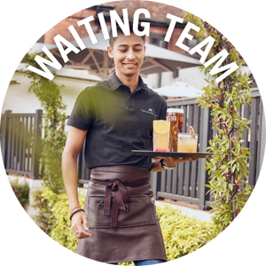 Waiting team member takes drinks to guests outside. Link to Waiting Team Jobs