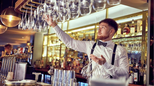Bar & Waiting Apprentice puts glasses back on the bar in Browns 